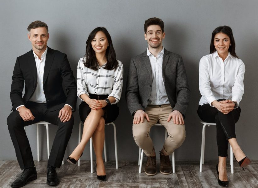 smiling-interracial-business-people-in-formal-wear-looking-at-camera-while-waiting-for-job-interview.jpg
